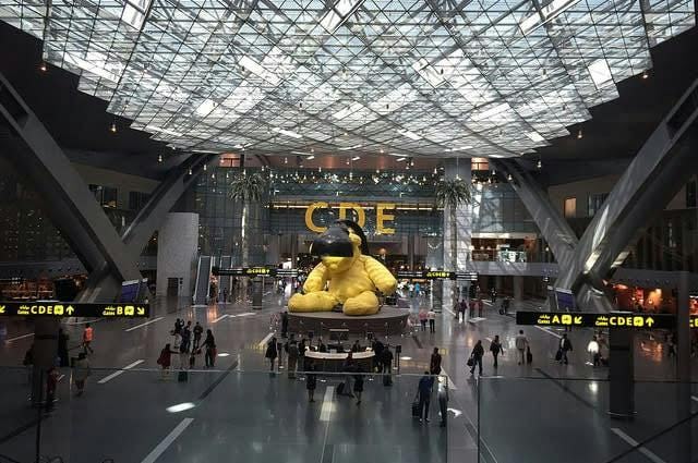 Doha Hamad airport with iconic yellow bear sculpture 