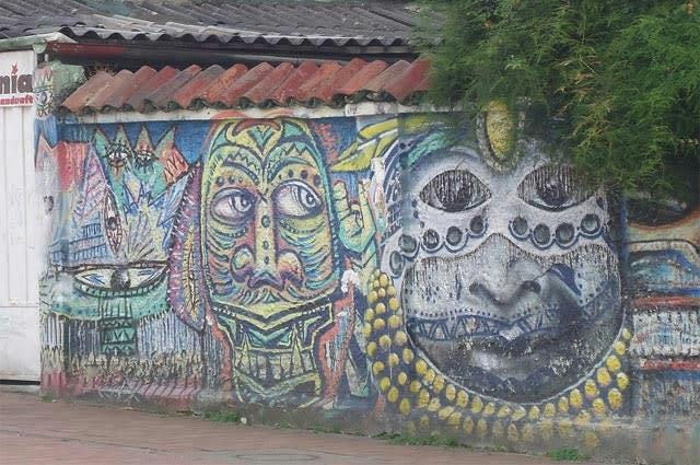 A shot of a street wall in Bogata which has been decorated by traditional style street art 